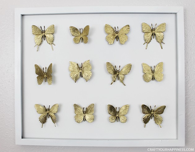 Hard to believe but this beautiful DIY framed butterfly decor piece was made with an old black frame that was missing the glass and some toy butterflies!