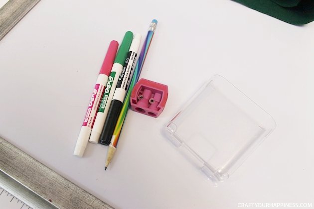 It's super easy to make any size DIY dry erase board using a roll of adhesive backed dry erase paper. We made a kitchen board and added some extras including making our own eraser!