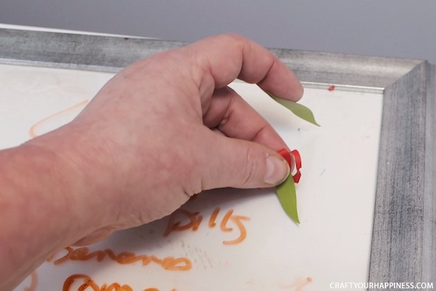 It's super easy to make any size DIY dry erase board using a roll of adhesive backed dry erase paper. We made a kitchen board and added some extras including making our own eraser!