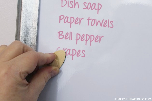 It's super easy to make any size DIY dry erase board using a roll of adhesive backed dry erase paper. We made a kitchen board and added some extras including making our own eraser!