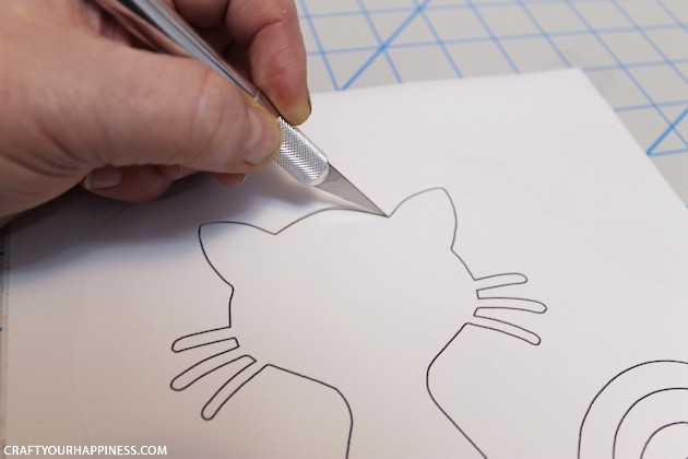 Making stencils from contact paper is cheap, lets you cut your own designs, you can make really big stencils and best of all, the stencil stays in place!