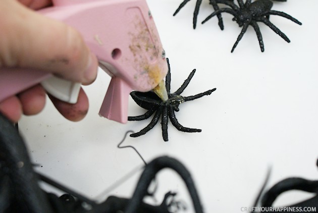 Make this creepy crawly DIY Halloween wreath to frighten up your door! It's cheap & quick to make. Use any bugs you like, but we choose spiders & snakes.