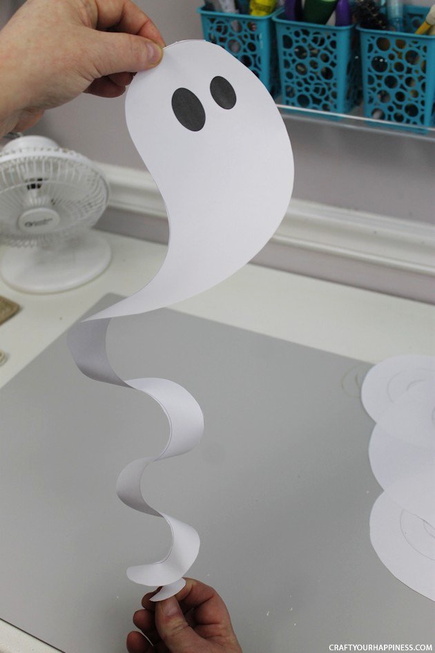 Need quick Halloween decorations? Grab our printables, some scissors or X-acto knife and before you know it you have have a room full of dangling ghosts!