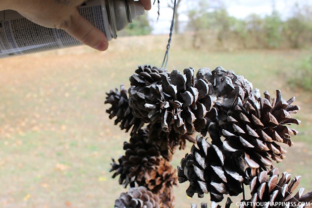 Learn how to make a pinecone wreath in 30 minutes! You can decorate the base wreath however you wish. We used a big red bow. Plus it's an upcycle project!