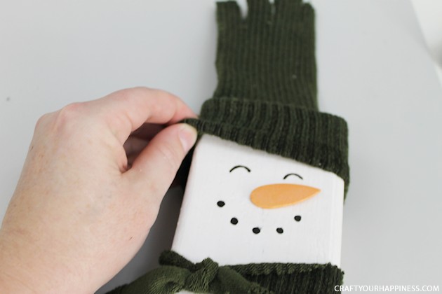 20 minutes is all you need to make this darling little inexpensive wooden snowman Christmas decor. Plus he won't melt! Great project for kids too!