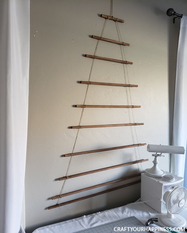 This easy DIY hanging wall Christmas tree made from dowels (or branches) is perfect if you're on a budget or you have very little space for a normal tree. 