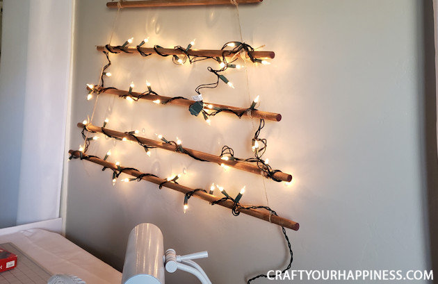 This easy DIY hanging wall Christmas tree made from dowels (or branches) is perfect if you're on a budget or you have very little space for a normal tree. 