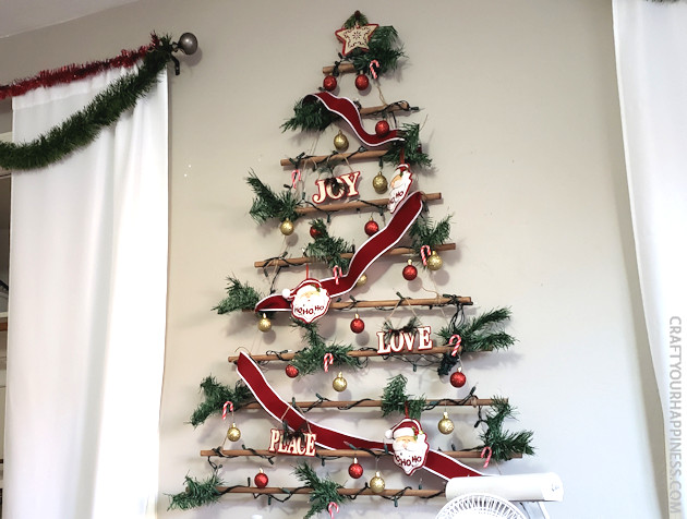 This easy DIY hanging wall Christmas tree made from dowels (or branches) is perfect if you're on a budget or you have very little space for a normal tree. 