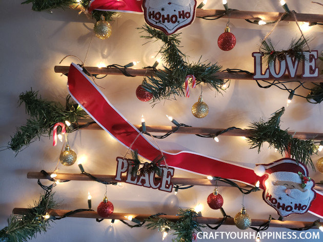 This easy DIY hanging wall Christmas tree made from dowels (or branches) is perfect if you're on a budget or you have very little space for a normal tree. 