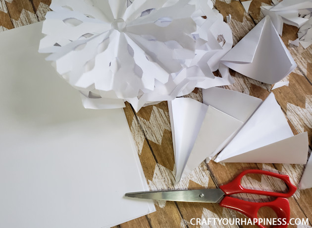 Make a Winter Wonderland for Pennies using only white paper, scissors and a stapler! Twinkle lights optional.  Free Snowflake Patterns included!