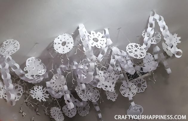 Make a Winter Wonderland for Pennies using only white paper, scissors and a stapler! Twinkle lights optional.  Free Snowflake Patterns included!