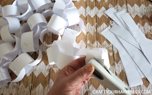 Make a Winter Wonderland for Pennies using only white paper, scissors and a stapler! Twinkle lights optional.  Free Snowflake Patterns included!