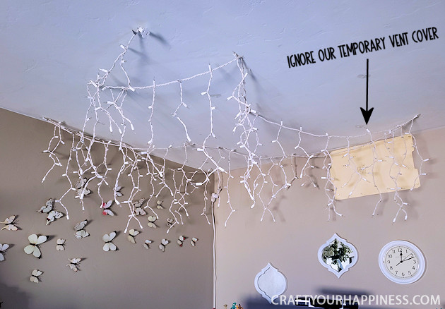 Looking for unusual inexpensive ceiling decorating ideas? Learn how to make our woodland twinkle light ceiling decor project. It's breathtaking!