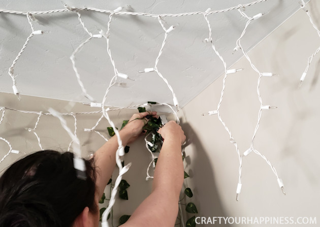 Looking for unusual inexpensive ceiling decorating ideas? Learn how to make our woodland twinkle light ceiling decor project. It's breathtaking!