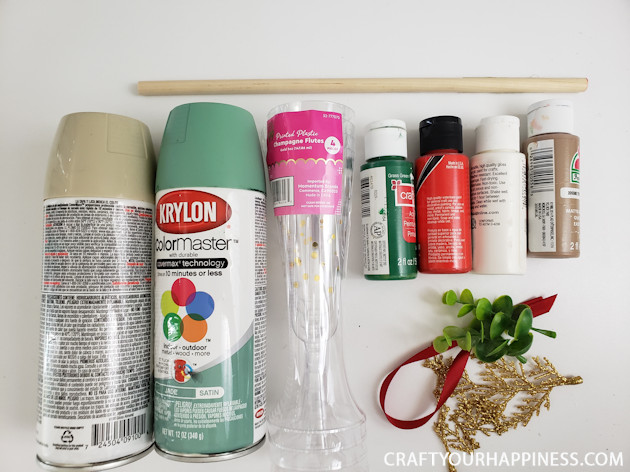 Looking for a simple DIY holiday craft? Make these plastic cup Christmas tree tabletop decor with champaign flutes from the dollar store!