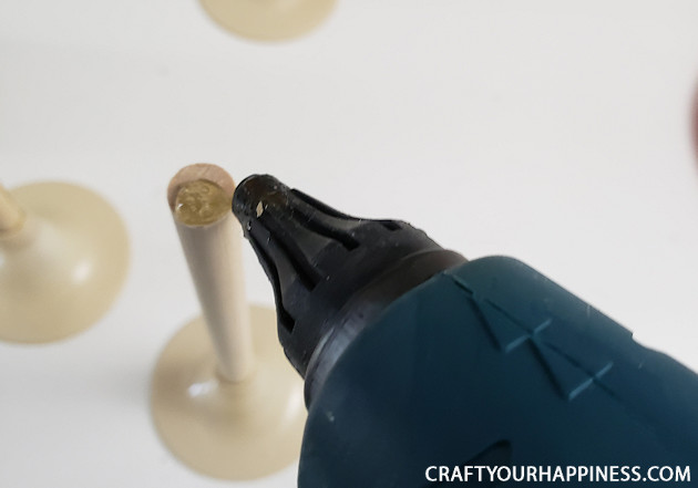 Looking for a simple DIY holiday craft? Make these plastic cup Christmas tree tabletop decor with champaign flutes from the dollar store!