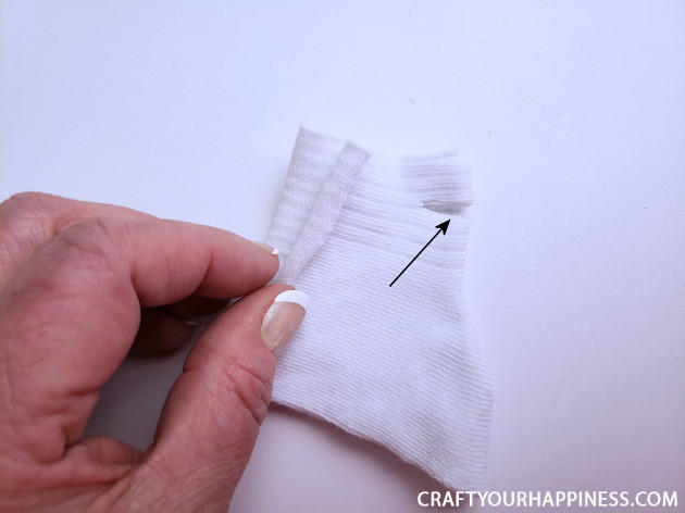 A 10 minute simple no-sew face mask made from a sock and filter material will help protect you and those you love from the spread of COVID-19.