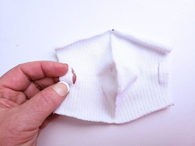 A 10 minute simple no-sew face mask made from a sock and filter material will help protect you and those you love from the spread of COVID-19.