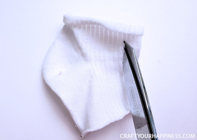A 10 minute simple no-sew face mask made from a sock and filter material will help protect you and those you love from the spread of COVID-19.