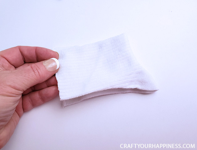 A 10 minute simple no-sew face mask made from a sock and filter material will help protect you and those you love from the spread of COVID-19.