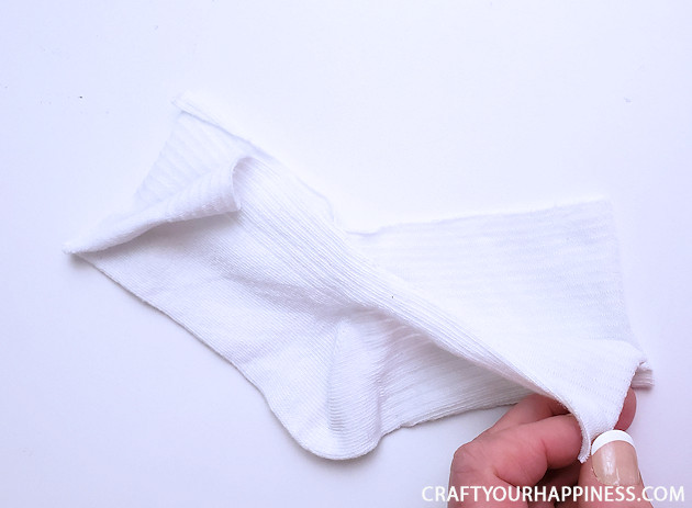 A 10 minute simple no-sew face mask made from a sock and filter material will help protect you and those you love from the spread of COVID-19.