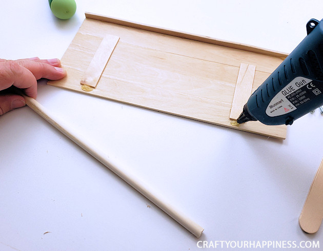 Check out our DIY TV top shelf made from paint sticks. This shelf sits on the top of your TV or monitor and can hold lightweight items!