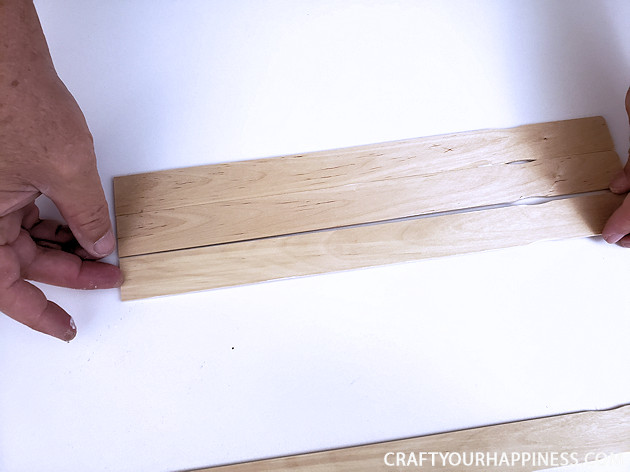 Check out our DIY TV top shelf made from paint sticks. This shelf sits on the top of your TV or monitor and can hold lightweight items!