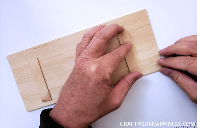 Check out our DIY TV top shelf made from paint sticks. This shelf sits on the top of your TV or monitor and can hold lightweight items!