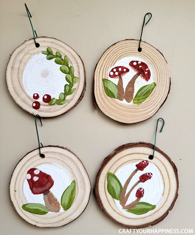 DIY paint your own wood slices Christmas ornaments for an earthy whimsical holiday vibe! You can buy the discs or cut your own!