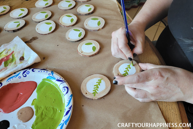 DIY paint your own wood slices Christmas ornaments for an earthy whimsical holiday vibe! You can buy the discs or cut your own!