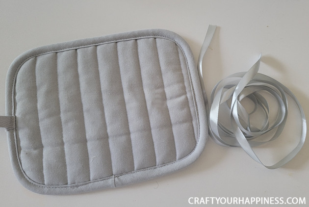 Make a DIY bowl cozy using a $2 hot pad! No more burned fingers trying to get a hot bowl out of the microwave. (No sewing machine needed!)