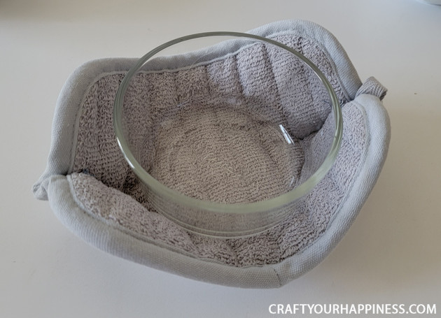 Make a DIY bowl cozy using a $2 hot pad! No more burned fingers trying to get a hot bowl out of the microwave. (No sewing machine needed!)