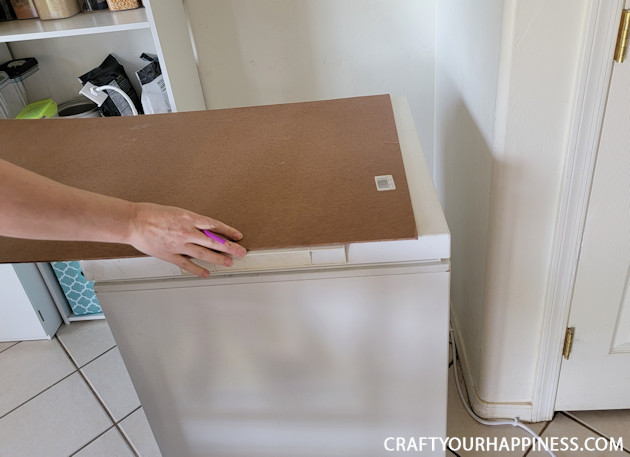 Learn how to make a chest freezer cover that lifts and can be painted or covered any way you like!  (It can also conceal an inventory list.)