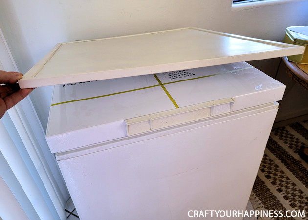 Learn how to make a chest freezer cover that lifts and can be painted or covered any way you like!  (It can also conceal an inventory list.)