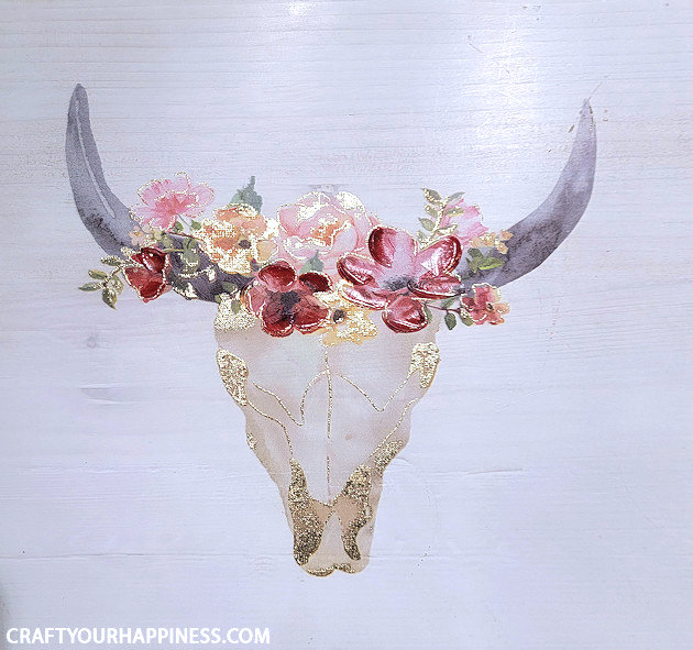 If you have old artwork that no longer fits your home decor here's a quick fun way to update it with a simple 3D painting makeover! Some artificial flowers and a hot glue gun is all we used!
